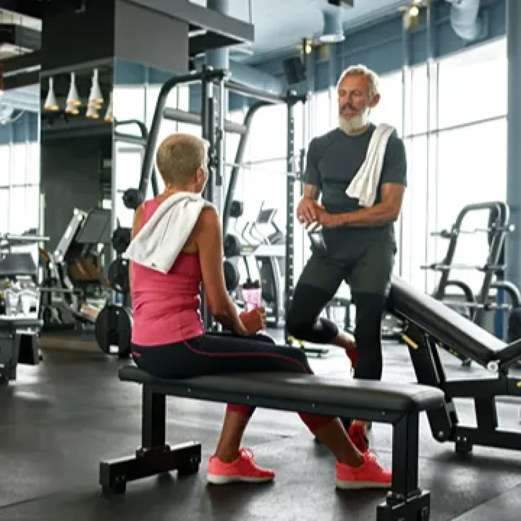 Home 9 Man working out in the gym with a personal trainer
