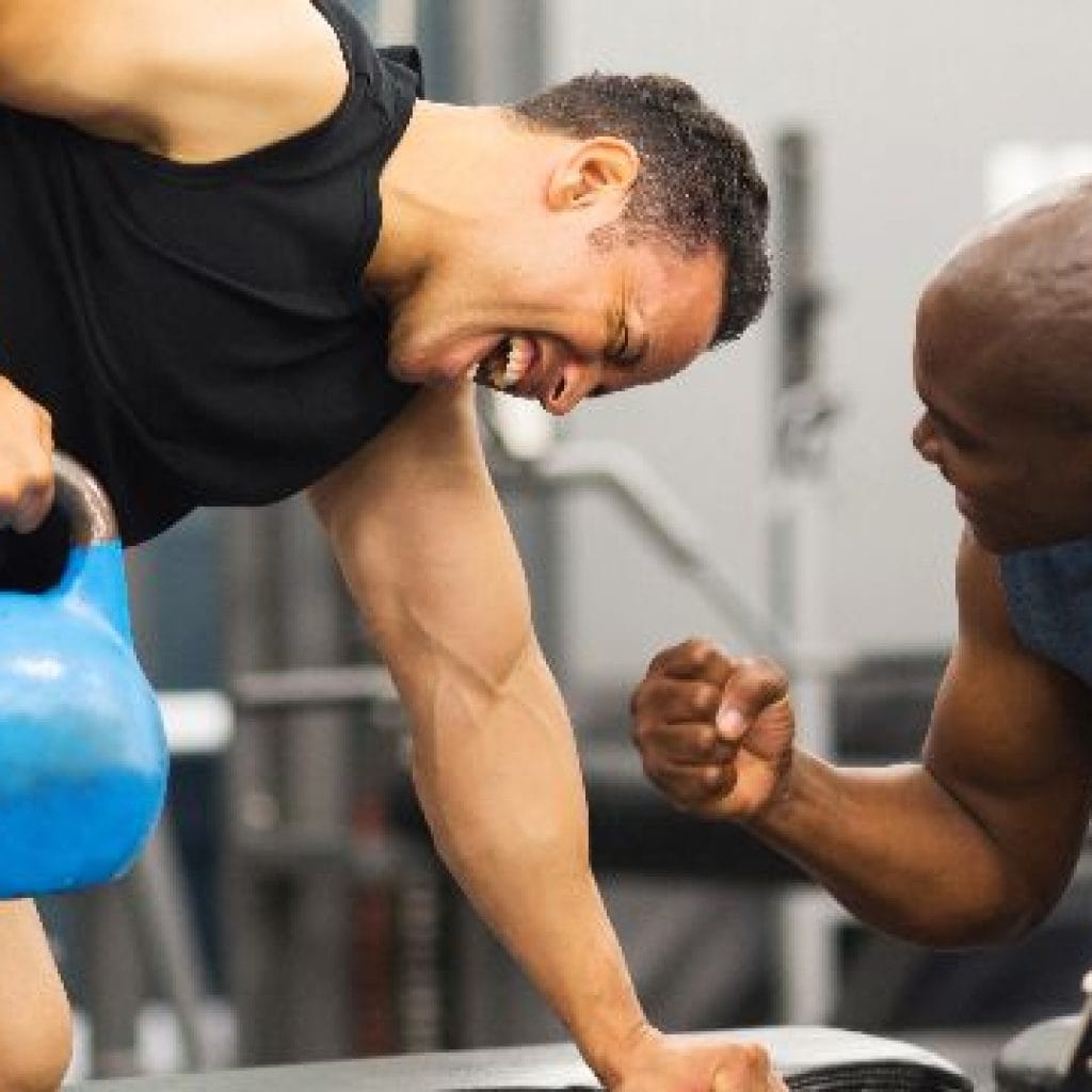 A man working out with a personal trainer.