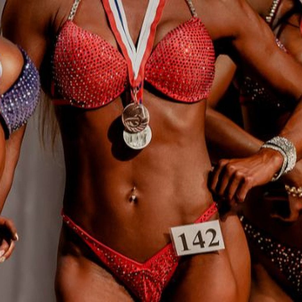 Three women bodybuilders in bikinis